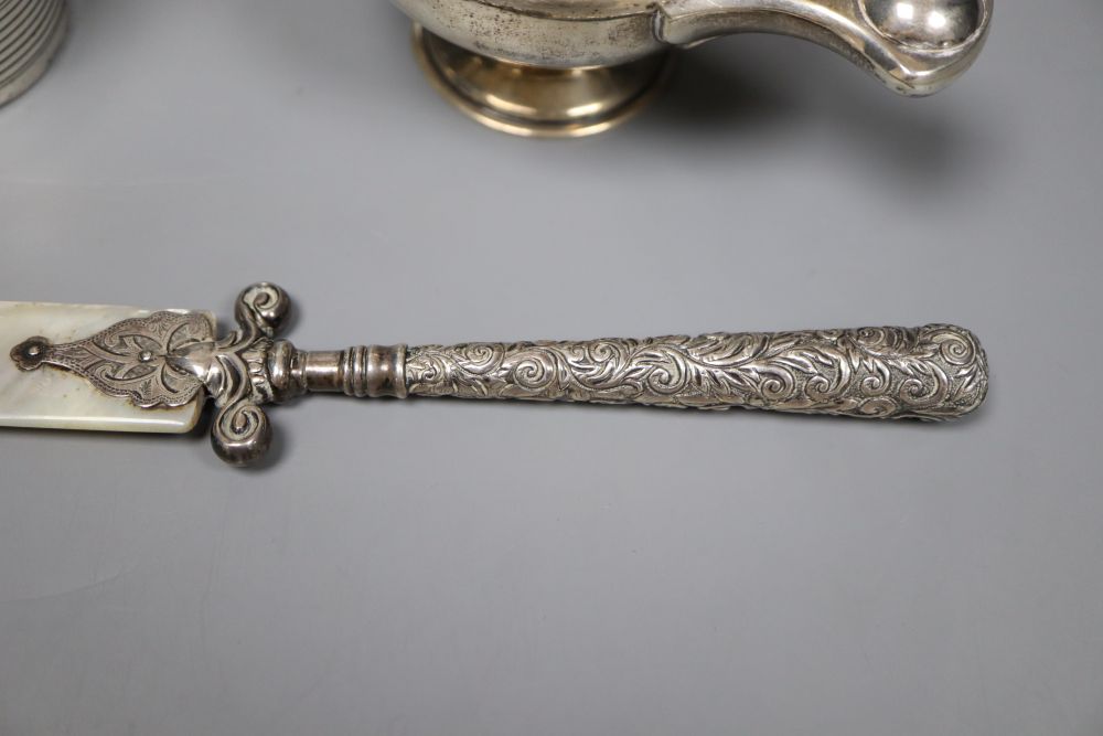 A George III reeded silver small mug, London, 1807, 6.3cm, an Edwardian Aladdins lamp perpetual lighter and a paper knife.